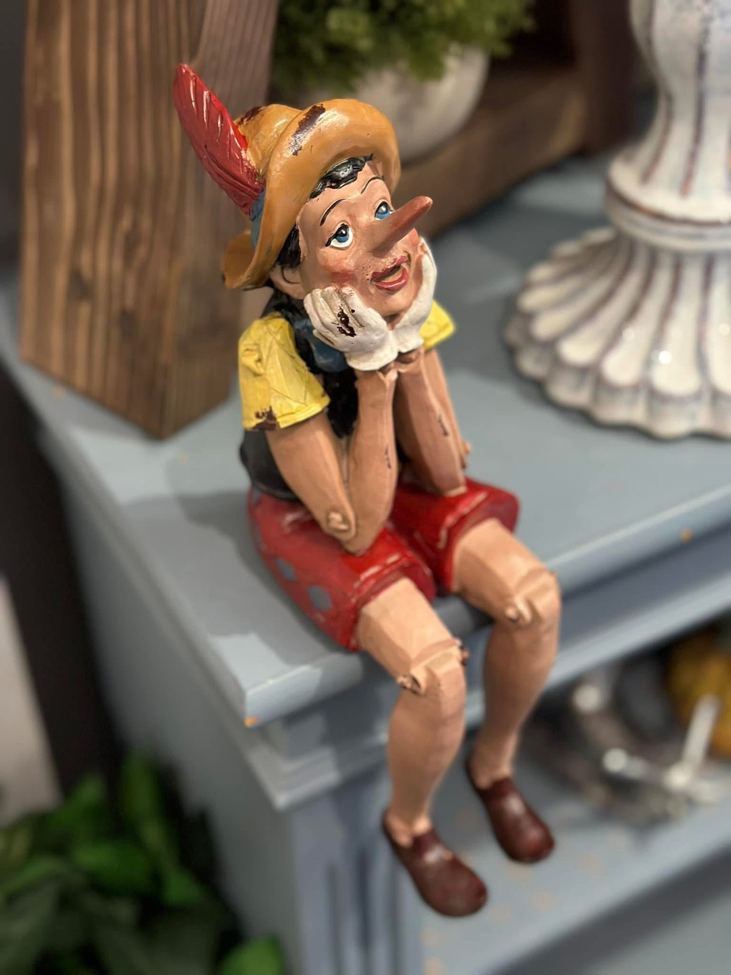 ANTIQUED SITTING PINOCCHIO FIGURE